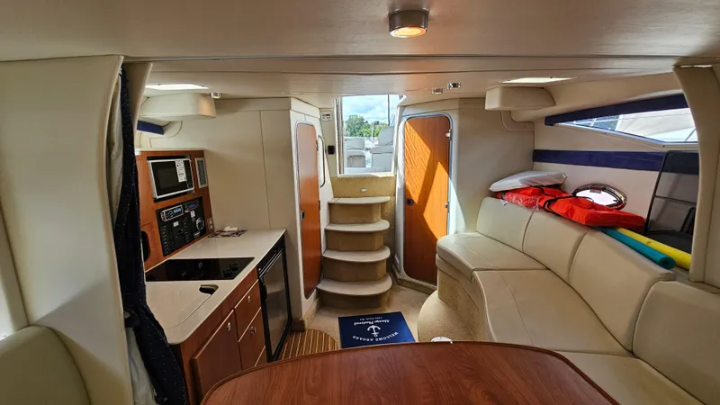 Slide: The Image of Interior of 2009 Bayliner 340 SB yacht with kitchen, seating, and stairs. - 21