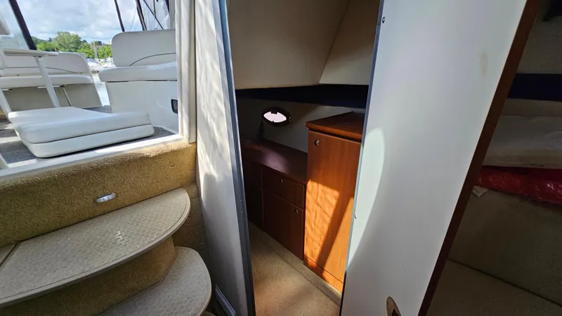 Slide: The Image of Interior view of 2009 Bayliner 340 SB boat cabin with stairs and wooden cabinet. - 22