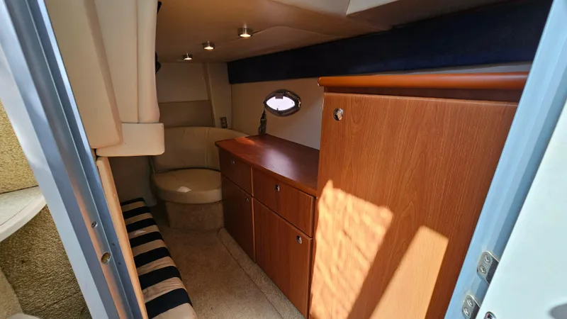Slide: The Image of 2009 Bayliner 340 SB cabin interior with wood cabinetry and seating. - 23