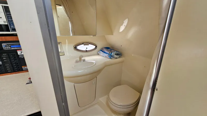 Slide: The Image of 2009 Bayliner 340 SB bathroom with sink, toilet, and mirror. - 26