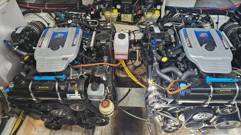 Slide: The Image of Twin engines in a 2009 Bayliner 340 SB boat, showcasing detailed mechanical components. - 27
