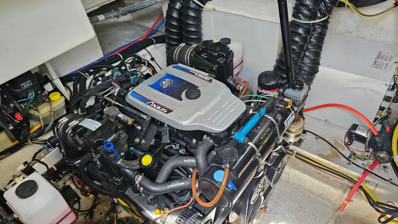 Slide: The Image of Engine compartment of a 2009 Bayliner 340 SB boat, showcasing detailed mechanical components. - 28