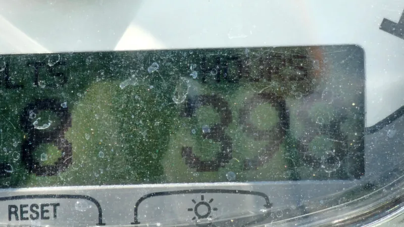 Slide: The Image of Close-up of a Bayliner 340 SB 2009 boat's hour meter displaying 393 hours. - 32