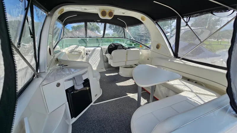 Slide: The Image of Interior of 2009 Bayliner 340 SB boat with seating, table, and kitchenette. - 4
