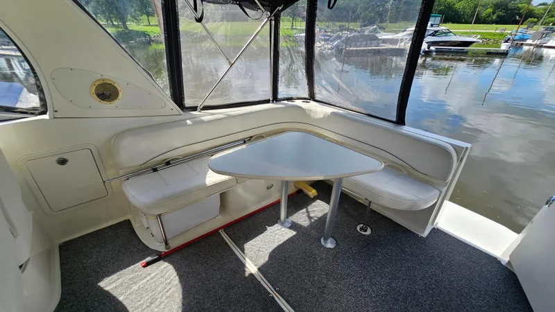Slide: The Image of Interior of 2009 Bayliner 340 SB boat with seating and table by the water. - 6
