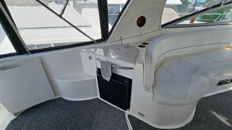 Slide: The Image of 2009 Bayliner 340 SB boat interior with sink, seating, and windows. - 7