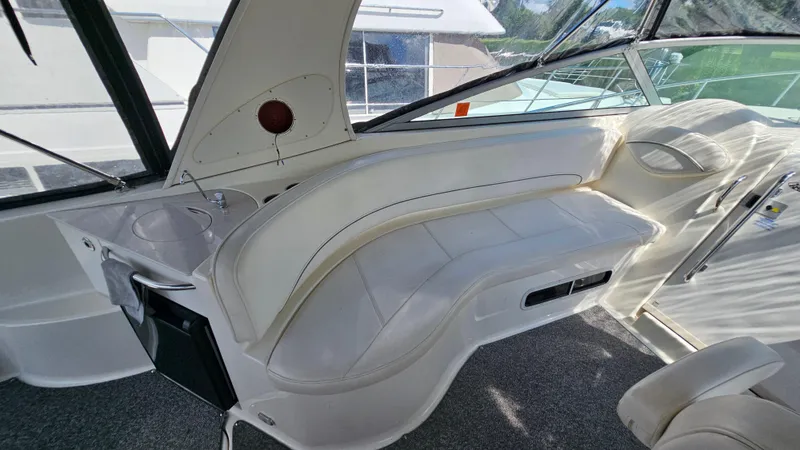 Slide: The Image of 2009 Bayliner 340 SB interior with white seating and compact sink area. - 8