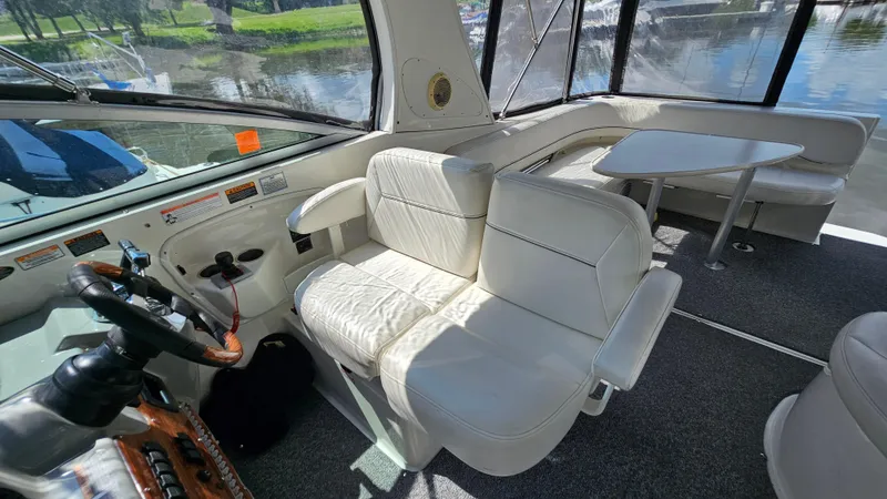 Slide: The Image of Interior of 2009 Bayliner 340 SB boat with white seating and steering wheel. - 9