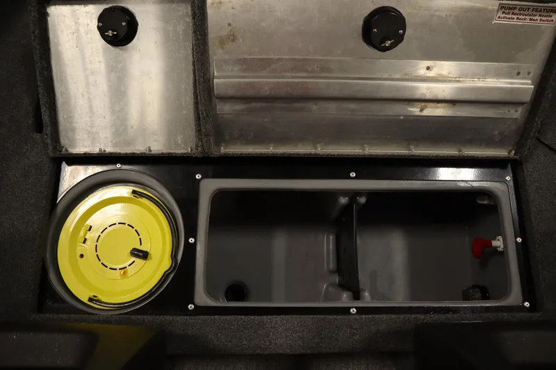 Slide: The Image of 2023 Tracker V16 Pro Guide WT boat storage compartment with yellow lid and pump-out feature. - 10