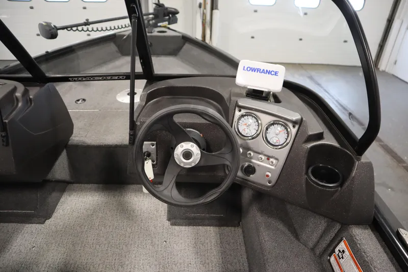 Slide: The Image of 2023 Tracker V16 Pro Guide WT boat dashboard with steering wheel and Lowrance display. - 12