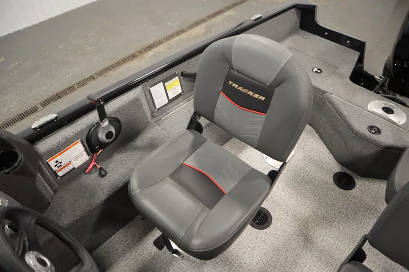 Slide: The Image of 2023 Tracker V16 Pro Guide WT boat interior with gray seating and control panel. - 22