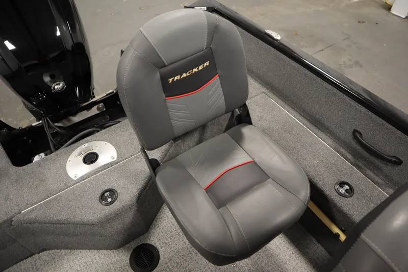 Slide: The Image of 2023 Tracker V16 Pro Guide WT boat seat with gray upholstery and red accents. - 29