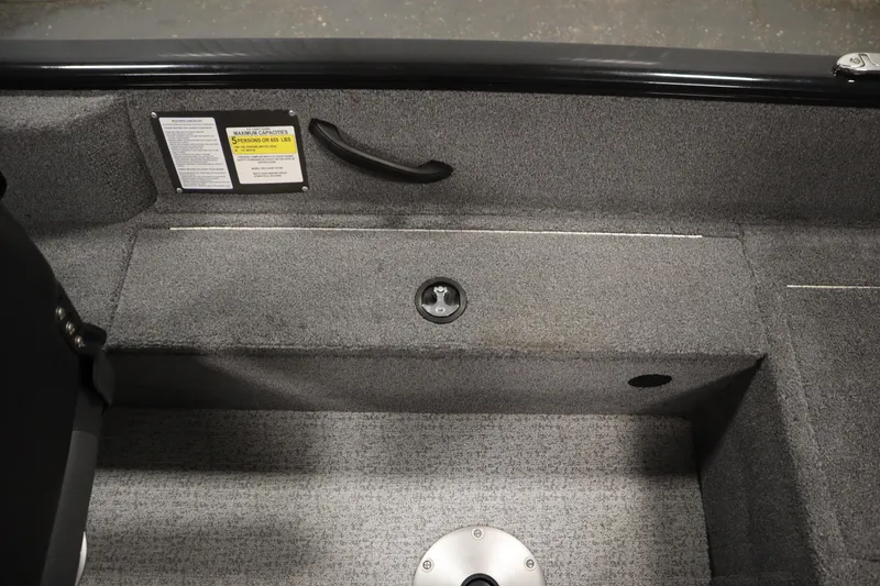 Slide: The Image of Interior of 2023 Tracker V16 Pro Guide WT boat, featuring gray carpet and seating area. - 33
