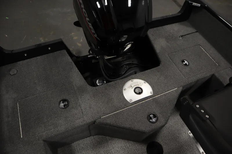 Slide: The Image of 2023 Tracker V16 Pro Guide WT boat interior with Mercury engine, showcasing storage compartments. - 35