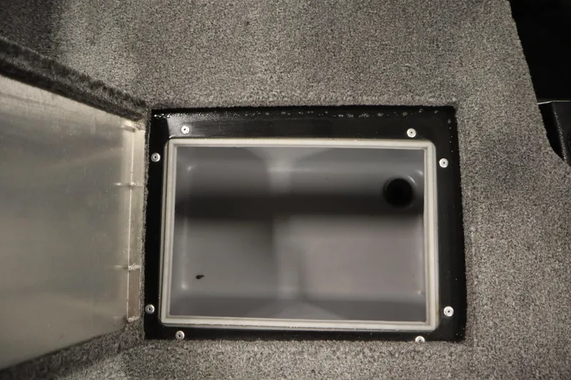 Slide: The Image of 2023 Tracker V16 Pro Guide WT boat storage compartment with gray carpeted interior. - 36