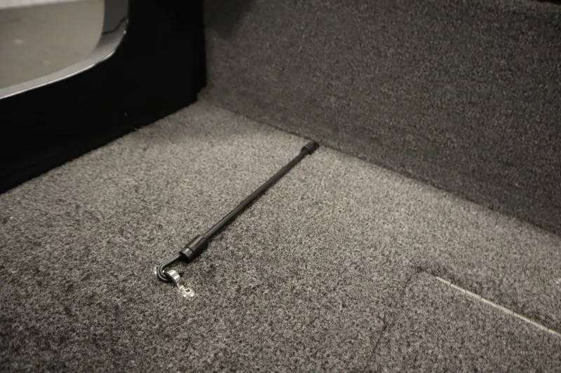 Slide: The Image of Carpeted interior of 2023 Tracker V16 Pro Guide WT boat, featuring a support rod. - 39