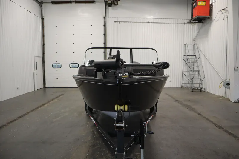Slide: The Image of 2023 Tracker V16 Pro Guide WT boat in a spacious indoor garage. - 42