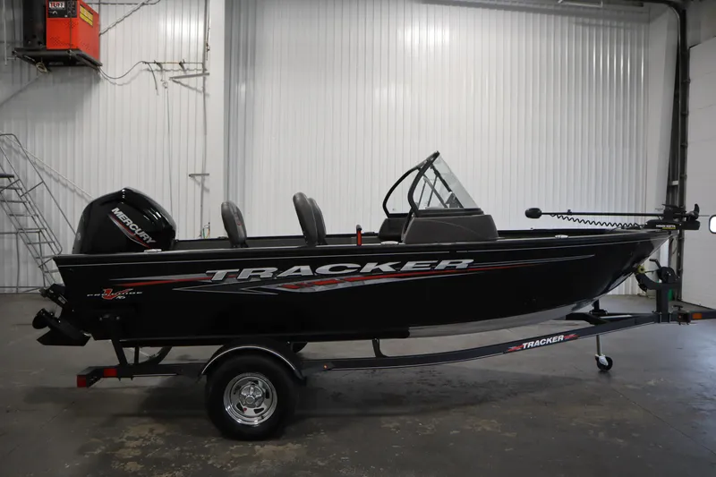 Slide: The Image of 2023 Tracker V16 Pro Guide WT boat in a garage setting. - 44