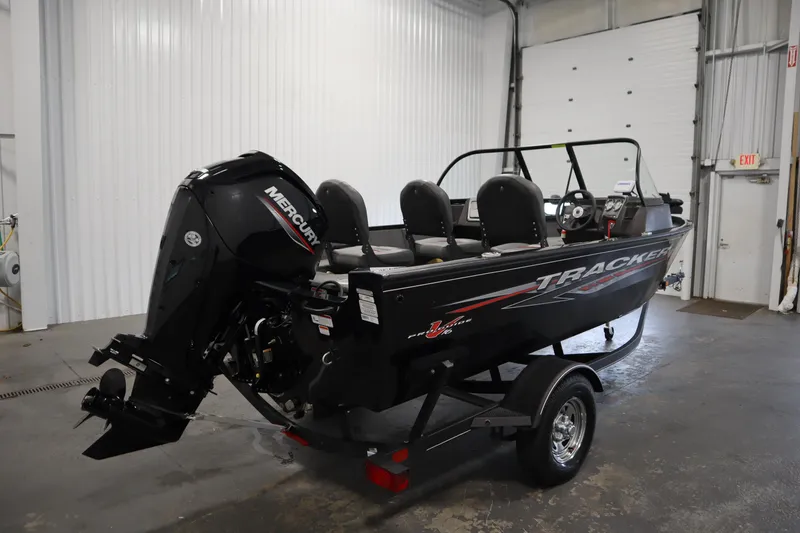 Slide: The Image of 2023 Tracker V16 Pro Guide WT boat with Mercury engine in a garage. - 45