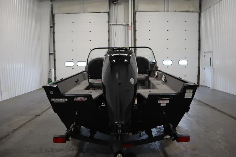 Slide: The Image of 2023 Tracker V16 Pro Guide WT boat in a garage, rear view. - 46