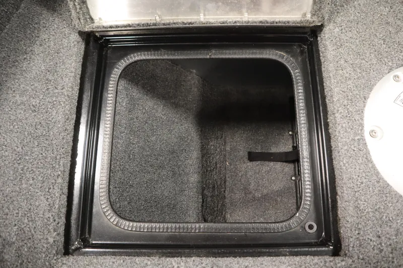 Slide: The Image of 2023 Tracker V16 Pro Guide WT storage compartment with carpeted interior and black frame. - 8