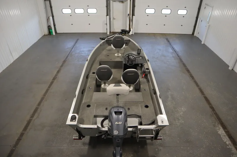 Slide: The Image of 2013 Alumacraft 165 Classic SC boat in a garage, featuring dual seats and a 50 HP motor. - 10