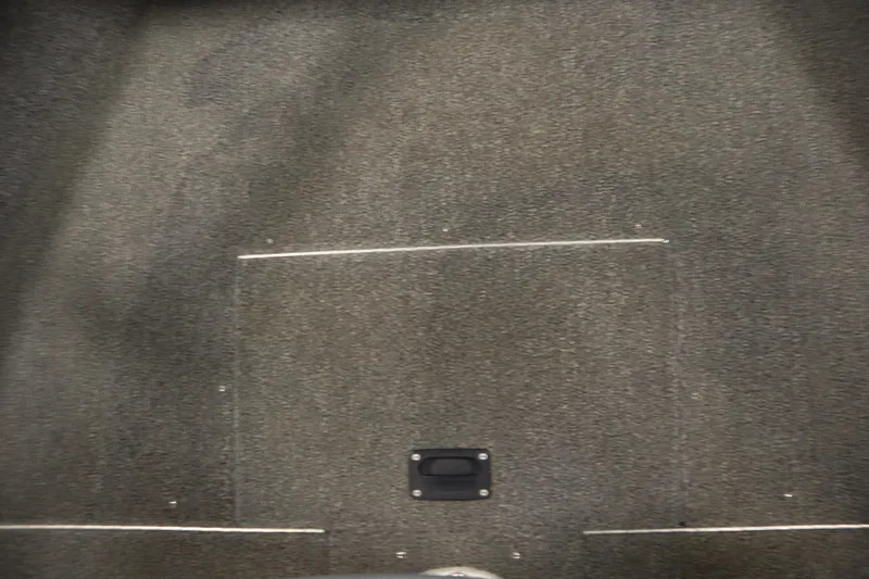 Slide: The Image of 2013 Alumacraft 165 Classic SC boat interior with carpeted flooring and storage hatch. - 16