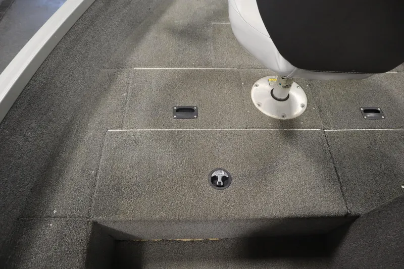 Slide: The Image of 2013 Alumacraft 165 Classic SC boat interior with carpeted flooring and swivel seat. - 19