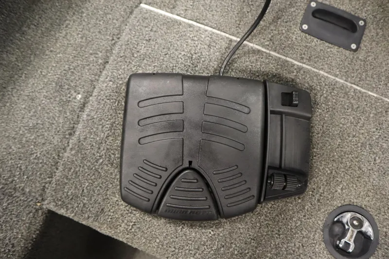 Slide: The Image of Foot pedal control on 2013 Alumacraft 165 Classic SC boat's carpeted floor. - 23