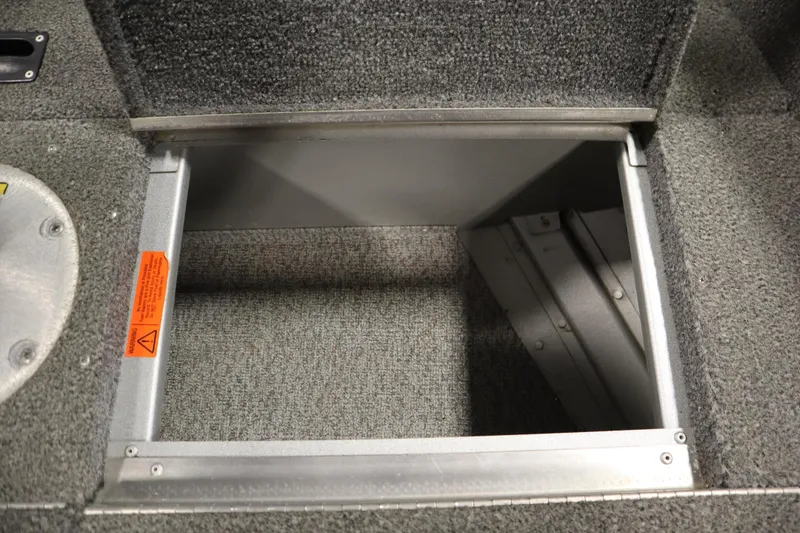 Slide: The Image of Open storage compartment in 2013 Alumacraft 165 Classic SC boat, featuring carpeted interior. - 24