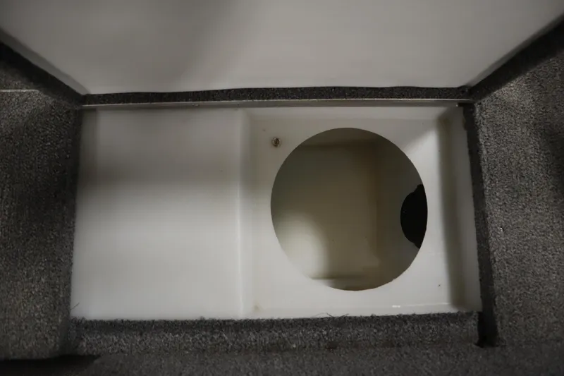 Slide: The Image of Storage compartment in 2013 Alumacraft 165 Classic SC boat, featuring carpeted interior. - 25