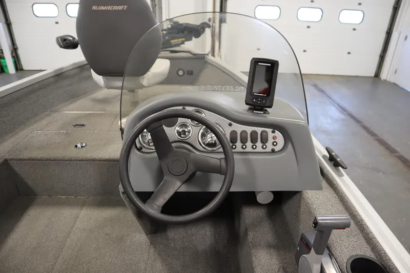 Slide: The Image of 2013 Alumacraft 165 Classic SC boat interior with steering wheel and control panel. - 27