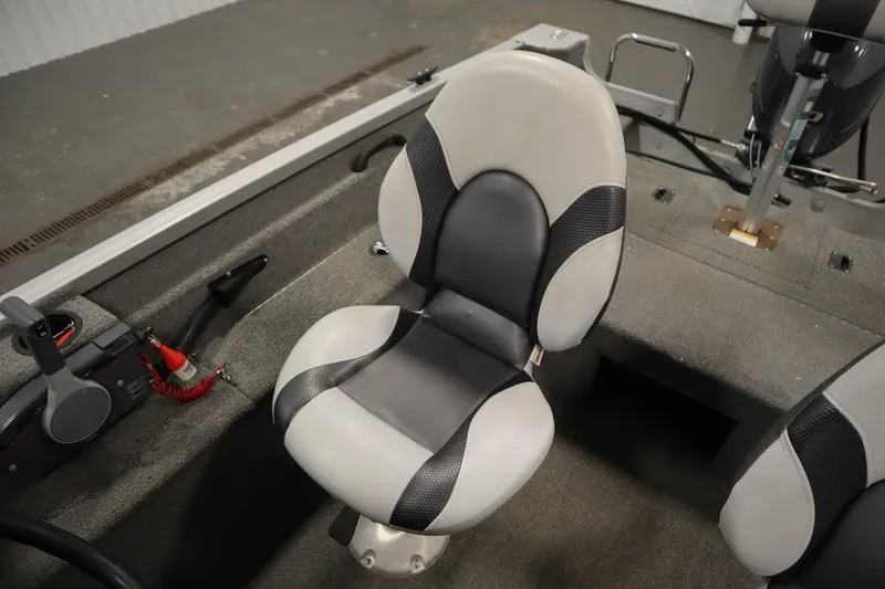 Slide: The Image of 2013 Alumacraft 165 Classic SC boat interior with cushioned seat and control panel. - 33