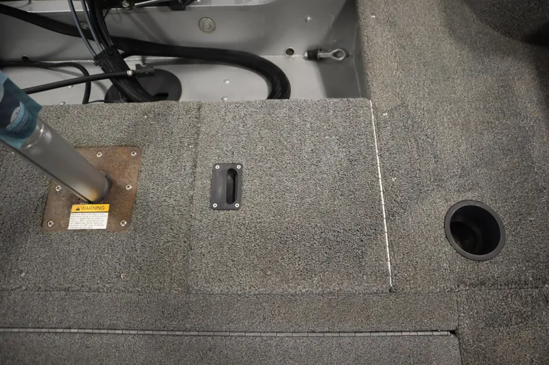 Slide: The Image of 2013 Alumacraft 165 Classic SC boat interior with carpeted flooring and seat base. - 43