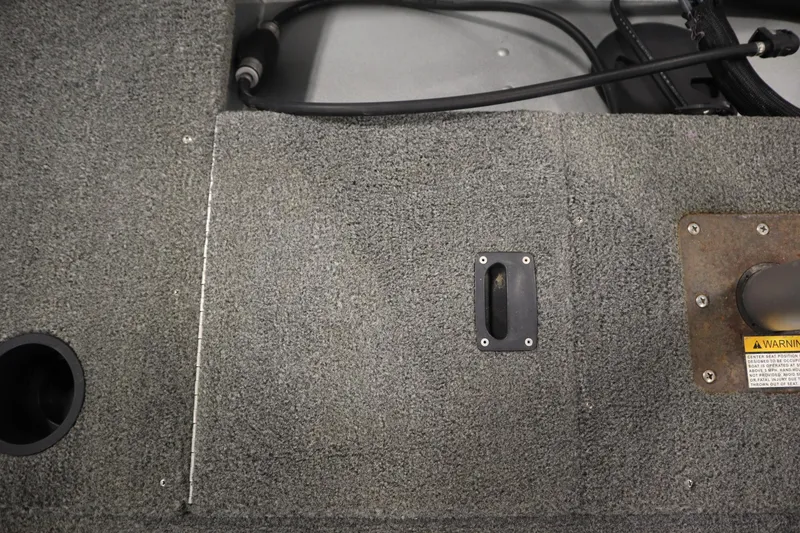 Slide: The Image of Carpeted deck of 2013 Alumacraft 165 Classic SC boat with storage compartment. - 45