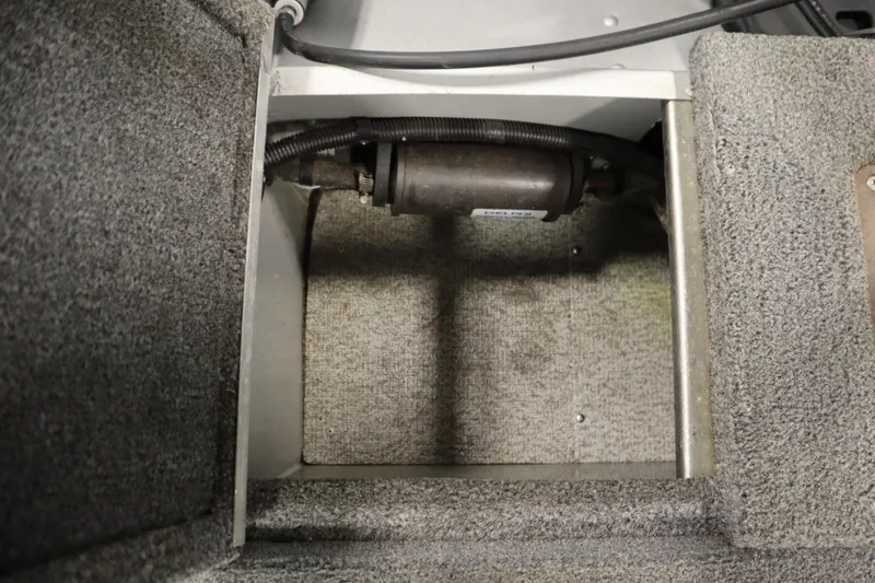 Slide: The Image of Interior compartment of a 2013 Alumacraft 165 Classic SC boat, showing wiring and carpeted surfaces. - 46