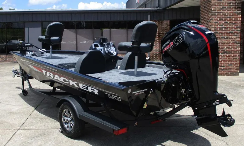 Slide: The Image of 2026 Tracker Pro Team™ 190 boat with Mercury Pro XS engine, parked outside a building. - 4