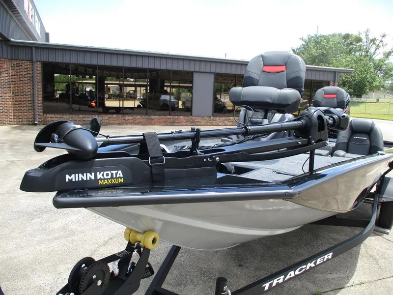 Slide: The Image of 2026 Tracker Pro Team™ 190 boat with Minn Kota Maxxum motor, parked outside a building. - 5