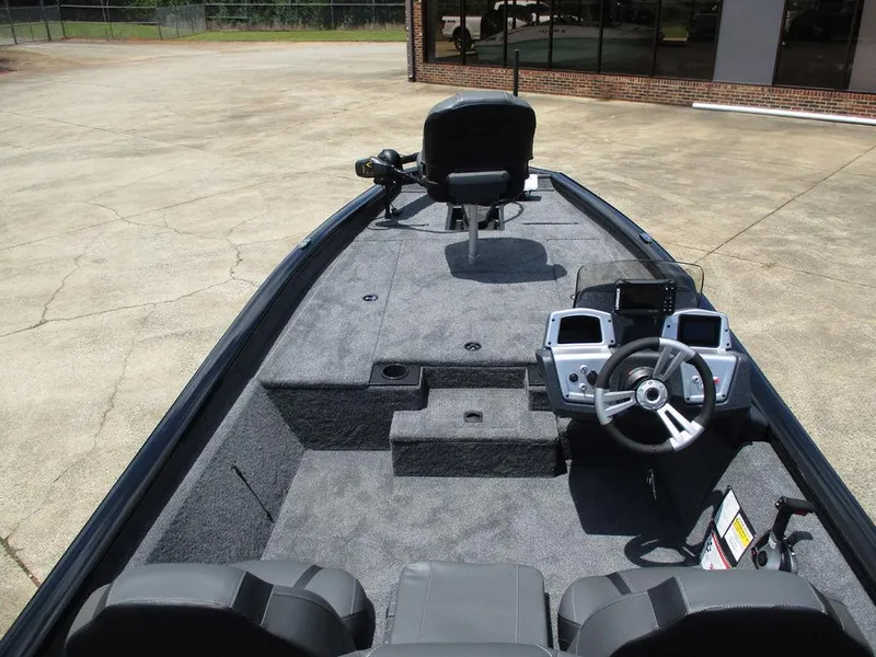 Slide: The Image of 2026 Tracker Pro Team™ 190 boat interior with steering console and seating. - 8