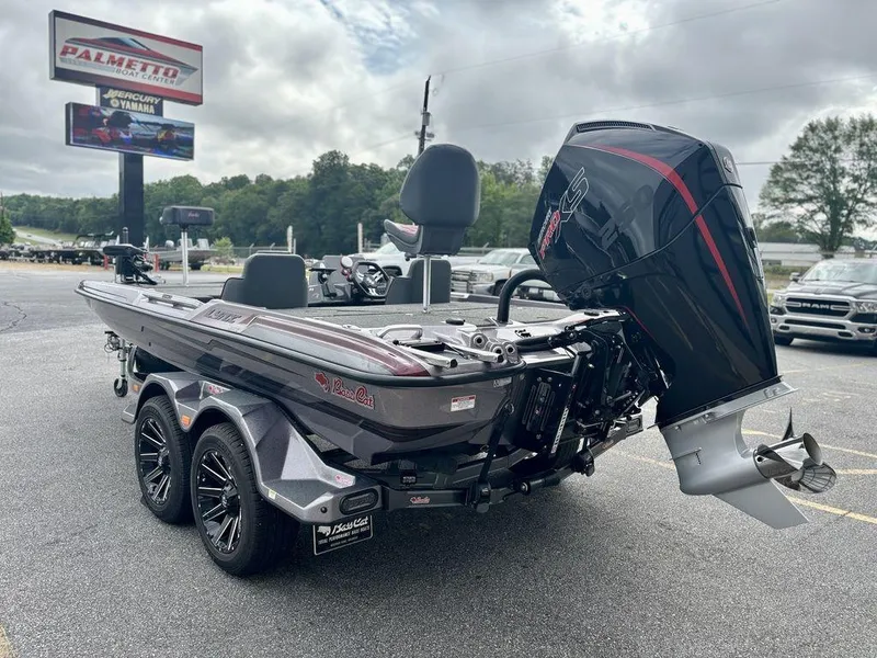 Slide: The Image of 2026 Bass Cat Lynx STS boat with powerful outboard motor at dealership. - 10