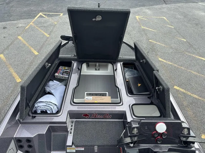 Slide: The Image of 2026 Bass Cat Lynx STS boat storage compartments open, showcasing organized interior space. - 14