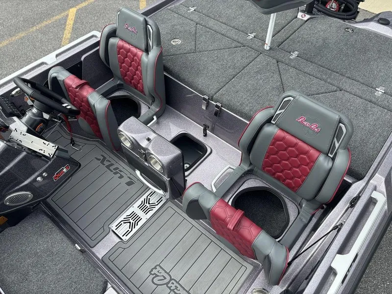 Slide: The Image of 2026 Bass Cat Lynx STS boat interior with red and gray seating, spacious layout. - 16