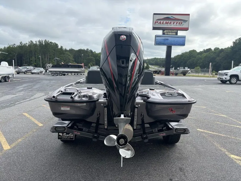 Slide: The Image of 2026 Bass Cat Lynx STS boat with powerful outboard motor in a dealership lot. - 3