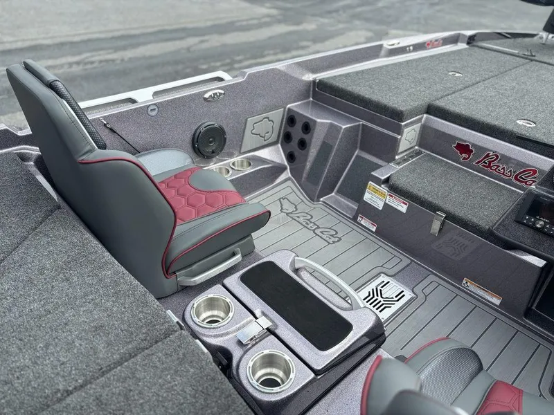 Slide: The Image of 2026 Bass Cat Lynx STS boat interior with gray and red seating, cup holders, and storage compartments. - 4