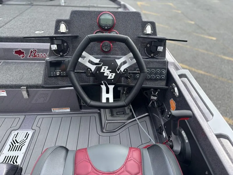 Slide: The Image of 2026 Bass Cat Lynx STS boat dashboard with steering wheel and controls. - 5