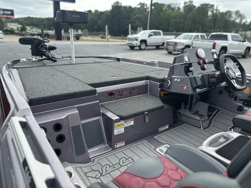 Slide: The Image of 2026 Bass Cat Lynx STS boat interior with steering console and seating area. - 6