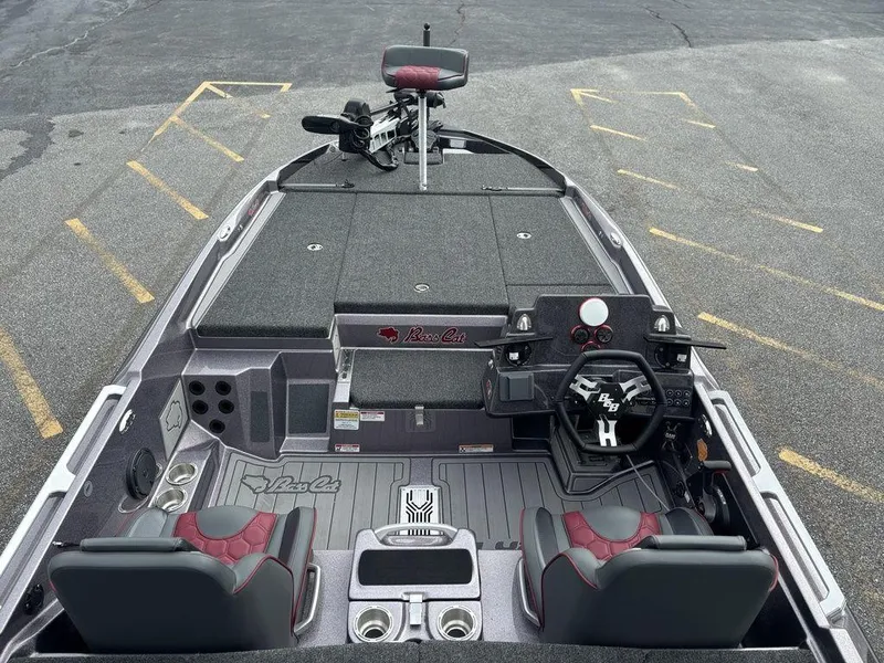 Slide: The Image of 2026 Bass Cat Lynx STS boat interior with steering wheel, seats, and control panel. - 7
