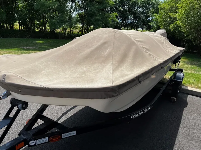The Image of Covered 1984 Tuffy Roustabout 149 boat on trailer, parked outdoors. - 1