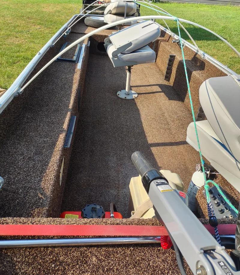 Slide: The Image of 1984 Tuffy Roustabout 149 boat interior with seating and fishing equipment. - 3