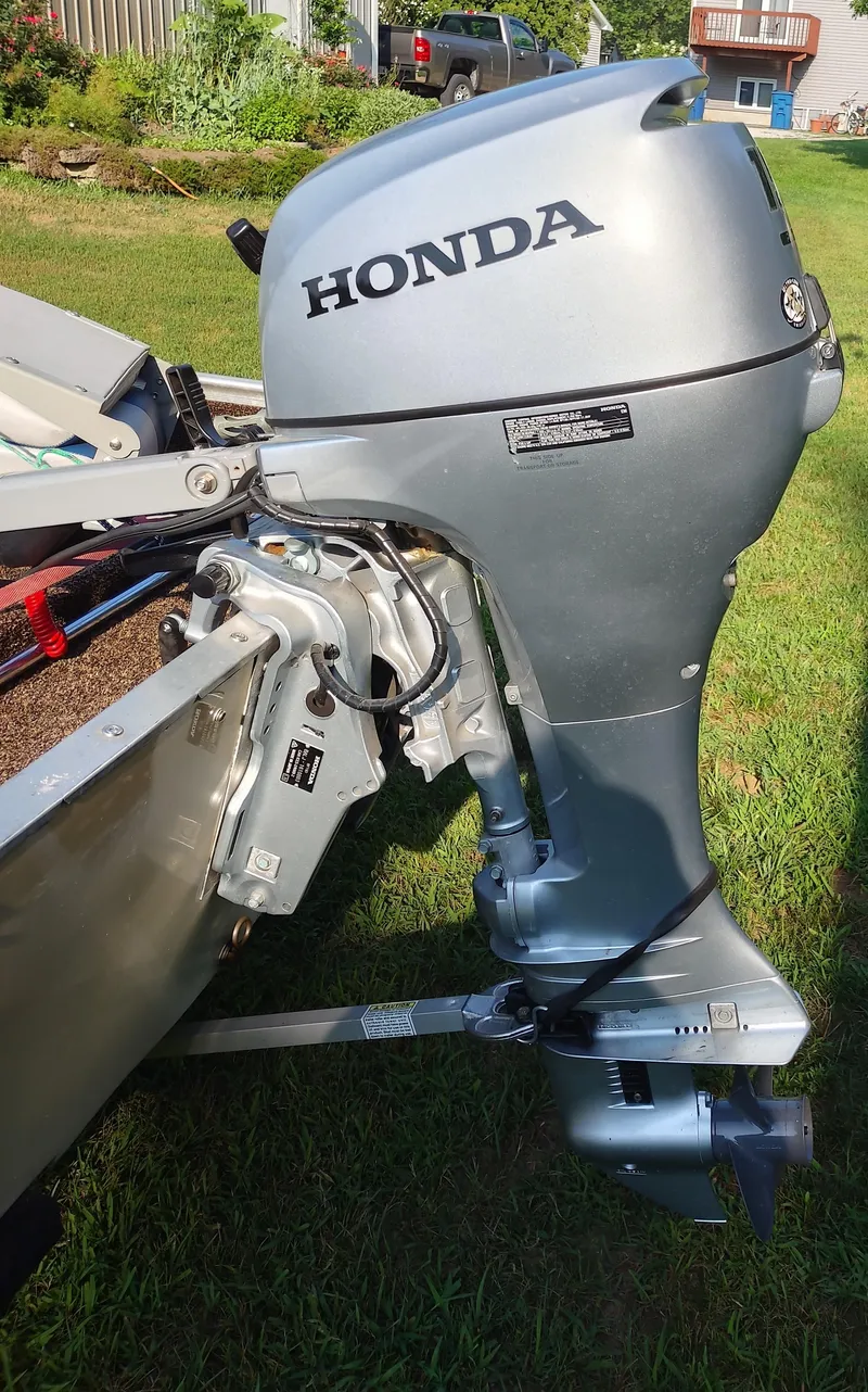 Slide: The Image of Silver Honda outboard motor attached to a Tuffy Roustabout 149 boat, 1984 model. - 7